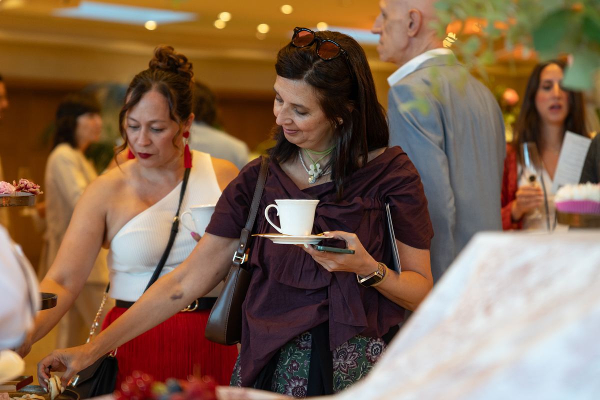 Guests with teacups at The Atrium station
