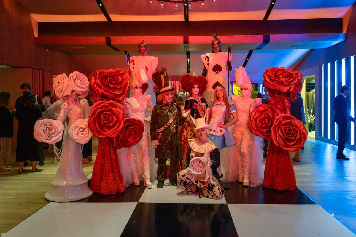 The cast of Alice in Wonderland characters posing in The Meadow hall