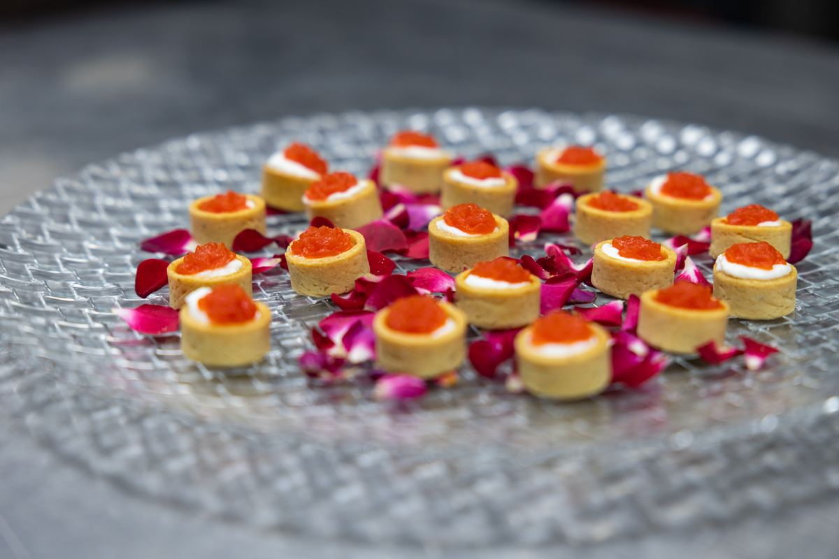 Tartlets on a glass tray with petals