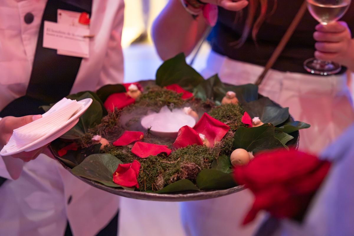 Bites served on a plate of moss and rose petals