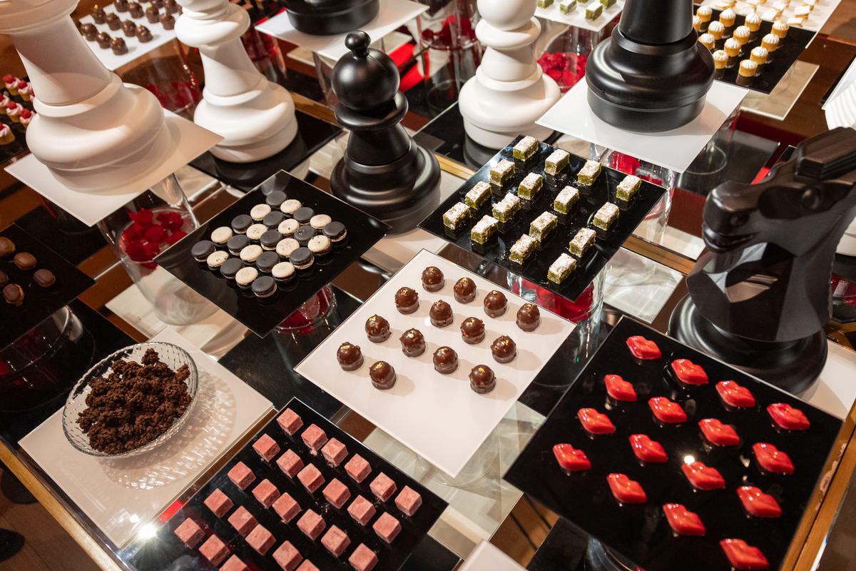 The Sweet Madness dessert table with truffles, red lips and giant chess pieces