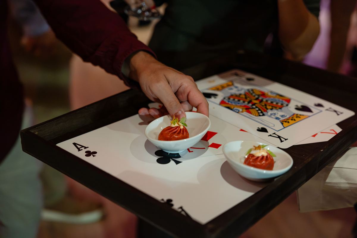 Bites served in bowls on a tray decorated as a playing card
