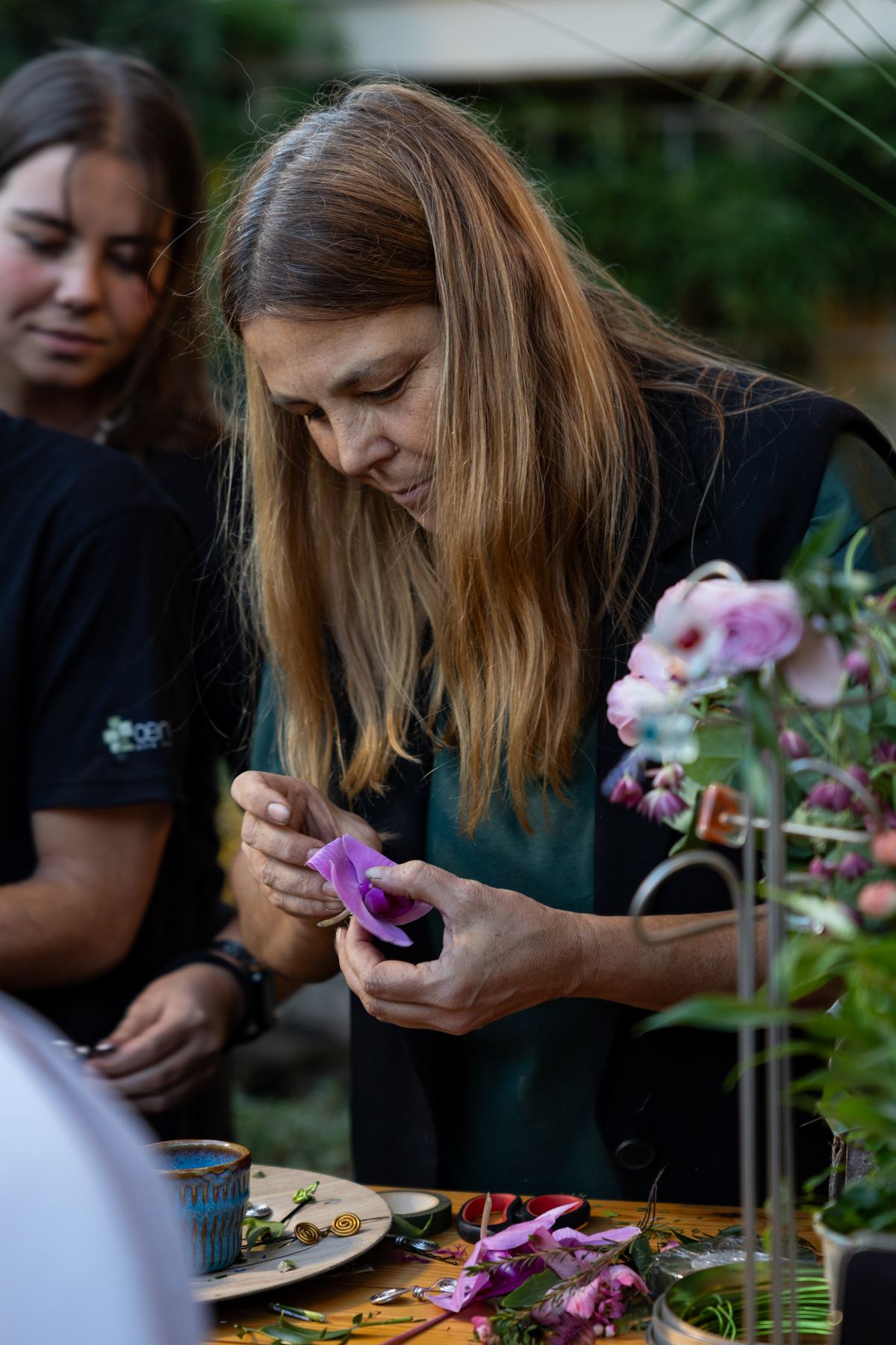 Guest choosing flowers at the florists' station, where flower crowns were made on the spot