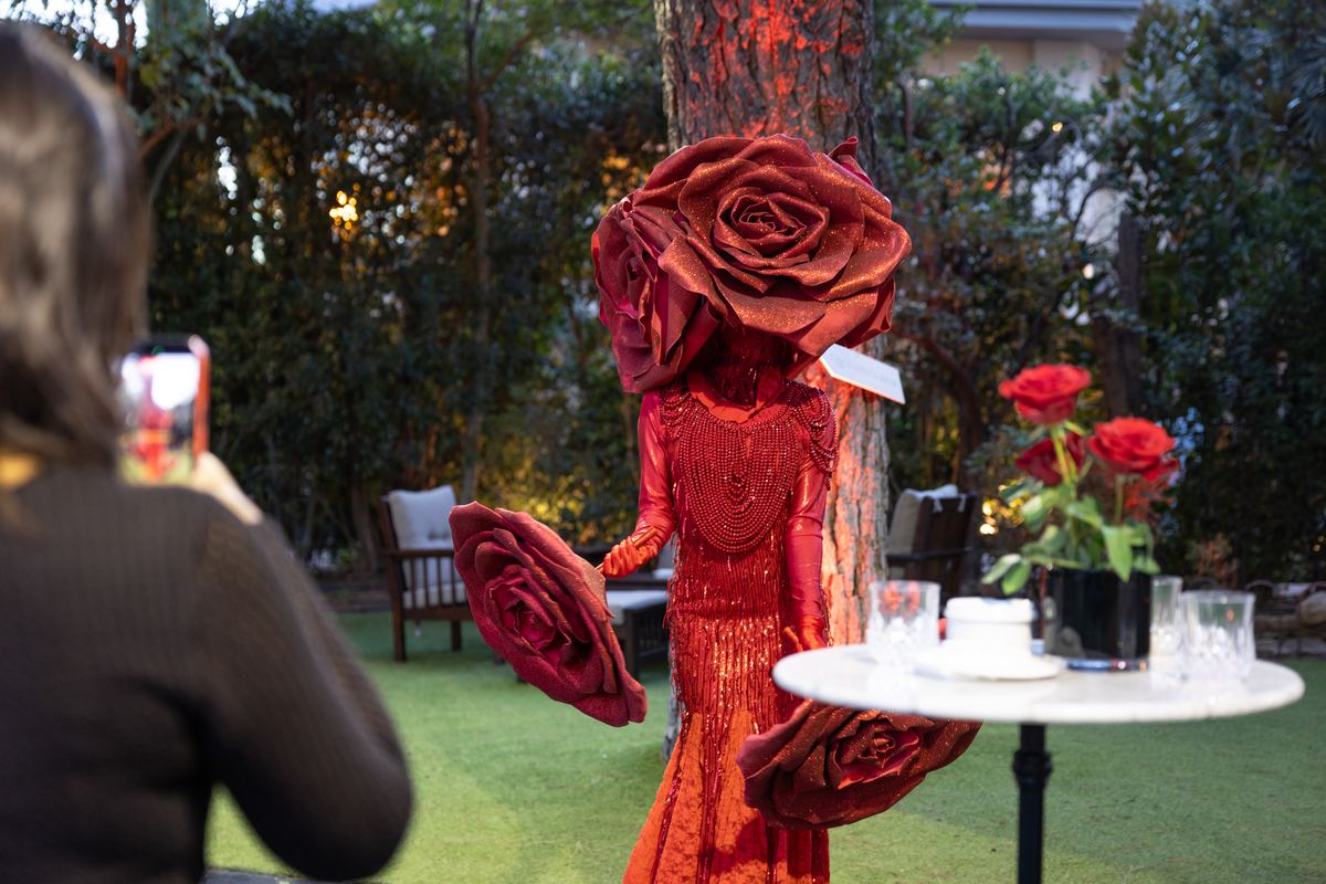 Actor dressed as a giant rose in the Red Queen's garden